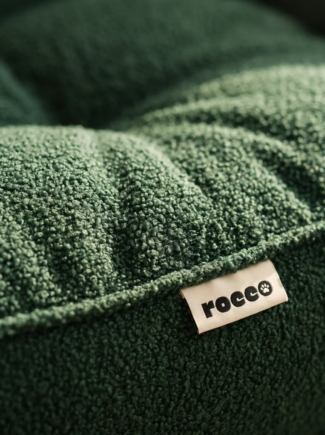Forest green boucle, close up, with the woven rocco label
